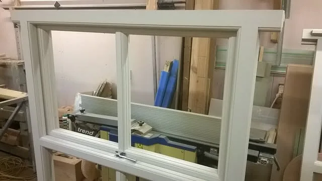 Painted timber window being completed in the joinery workshop